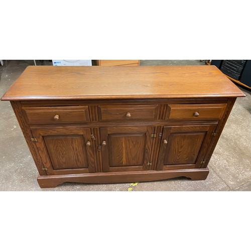 93 - JAYCEE OAK THREE DOOR DRESSER BASE