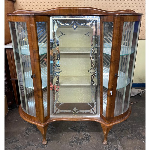 223 - 1950S WALNUT BOWED AND INVERTED BREAKFRONTGLAZED CABINET