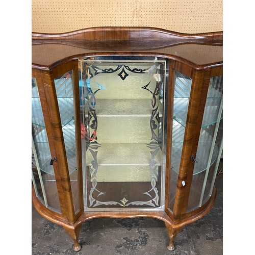 223 - 1950S WALNUT BOWED AND INVERTED BREAKFRONTGLAZED CABINET