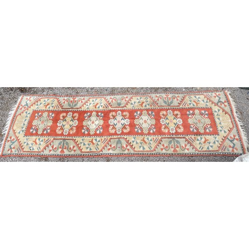 233 - 20TH CENTURY CAUCASIAN CARPET RUNNER WITH LOZENGE MEDALLIONS ON A CENTRAL RUSSET PANEL WITHIN GEOMET... 