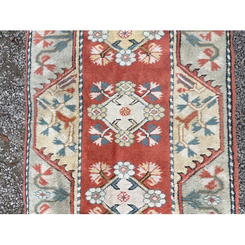 233 - 20TH CENTURY CAUCASIAN CARPET RUNNER WITH LOZENGE MEDALLIONS ON A CENTRAL RUSSET PANEL WITHIN GEOMET... 