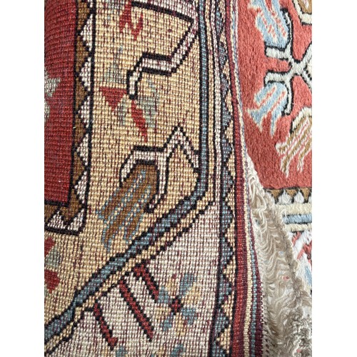 231 - 20TH CENTURY CAUCASIAN CARPET RUNNER WITH GEOMETRIC PATTERN ON TERRACOTTA CENTRAL GROUND 82CM X 282C... 