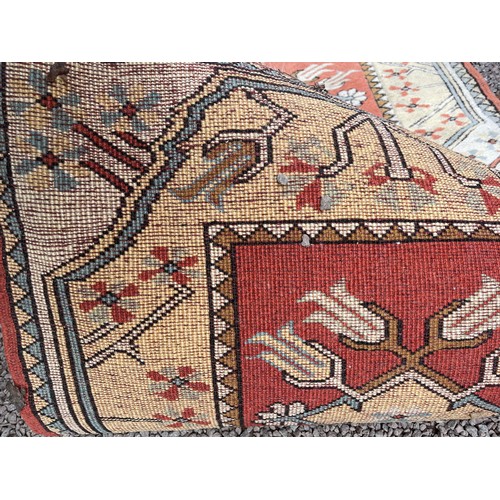 231 - 20TH CENTURY CAUCASIAN CARPET RUNNER WITH GEOMETRIC PATTERN ON TERRACOTTA CENTRAL GROUND 82CM X 282C... 