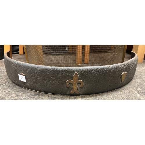 7 - CAST IRON DEMI LUNE FIRE CURB WITH FLEUR DE LYS  DECORATION AND MESH FIRE GUARD