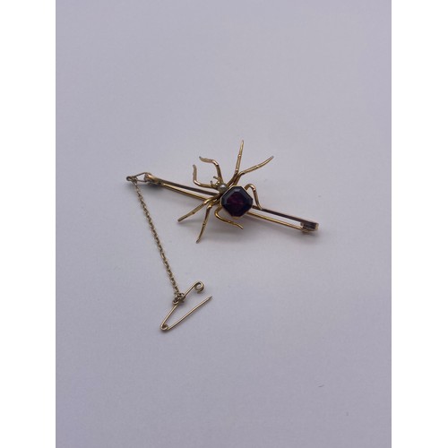 765 - 9CT ROSE AND YELLOW GOLD SPIDER BAR BROOCH INSET WITH AMETHYST AND PEARL WITH SAFETY CHAIN 6.5G OVER... 