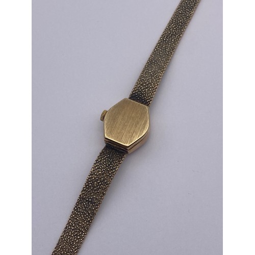 766 - 9CT LADIES MARVIN REVIEW QUARTZ WRISTWATCH ON TEXTURED LATTICE STRAP 16.7G OVERALL APPROX