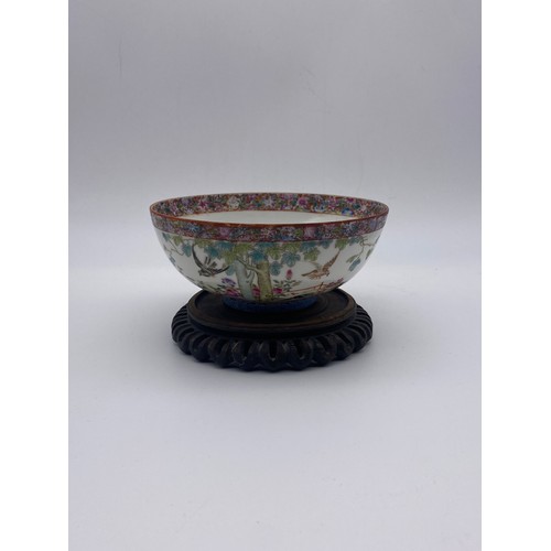 713 - CHINESE EXPORT PORCELAIN SHALLOW BOWL DECORATED WITH BIRDS IN GARDEN LANDSCAPE WITH MILLE FLEUR INTE...