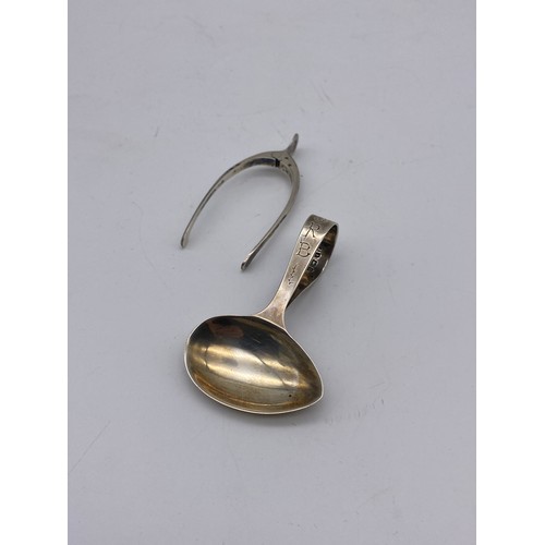 672 - BIRMINGHAM SILVER CHILDS FEEDER SPOON AND A NOVELTY PAIR OF WISH BONE SUGAR TONGS