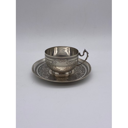 660 - 800 WHITE METAL ENGRAVED CUP AND SAUCER