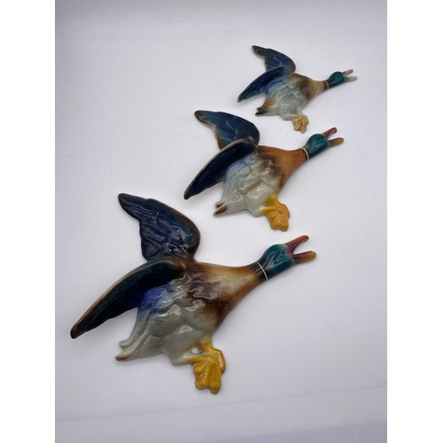 719 - SET OF THREE GRADUATED POTTERY WALL DUCK PLAQUES