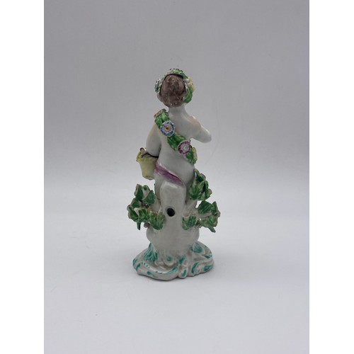 696 - 18TH CENTURY BOW PORCELAIN FIGURE OF A PUTTO WITH FLOWER BASKET A/F (RED ANCHOR AND DAGGER MARK TO B... 