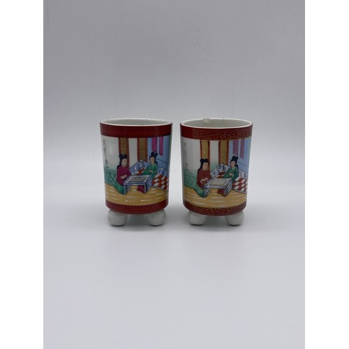 698 - PAIR OF CHINESE CYLINDRICAL POTS ON RAISED BALL FEET WITH SCRIPT TO VERSO A/F