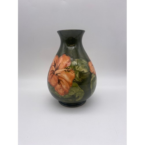 601 - MOORCROFT POTTERY HIBISCUS PATTERN BALUSTER VASE ON GREEN GROUND