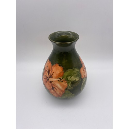 601 - MOORCROFT POTTERY HIBISCUS PATTERN BALUSTER VASE ON GREEN GROUND