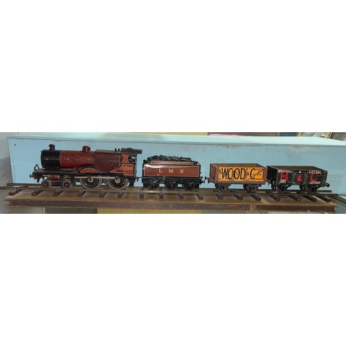 645 - TIN PLATE SCALE MODEL 0 GUAGE BASSETT LOWKE LMS STEAM TRAIN AND TWO WAGONS ON DISPLAY TRACK