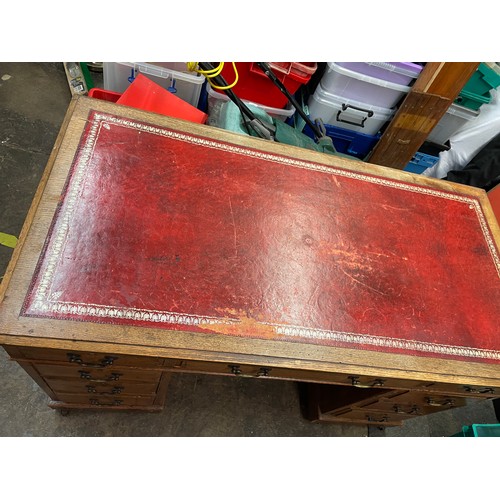 27 - LATE VICTORIAN OAK NINE DRAWER KNEEHOLE DESK WITH RED LEATHER INSET SCIVER