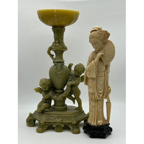 312 - IVORINE OKIMONO OF A GEISHA AND RESIN CHERUB TABLE CENTREPIECE