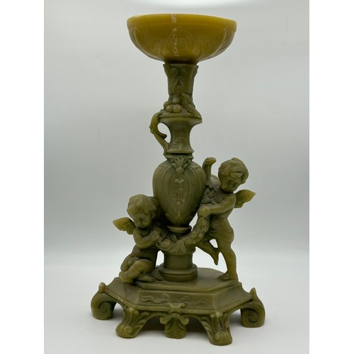 312 - IVORINE OKIMONO OF A GEISHA AND RESIN CHERUB TABLE CENTREPIECE