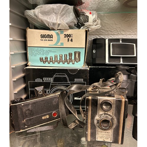 434 - SHELF OF CAMERAS AND ACCESSORIES INCLUDING KODAK, VIVITAR, AND A CORONET BOX CAMERA