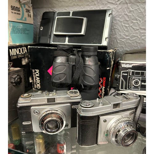 434 - SHELF OF CAMERAS AND ACCESSORIES INCLUDING KODAK, VIVITAR, AND A CORONET BOX CAMERA