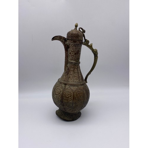 567 - EASTERN COPPER AND BRASS HANDLED ENGRAVED EWER