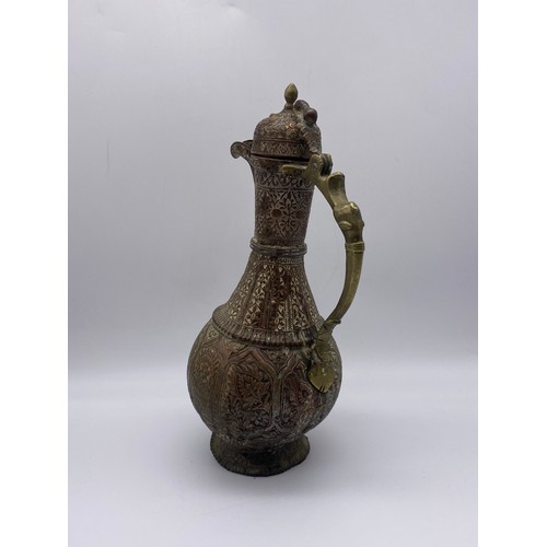 567 - EASTERN COPPER AND BRASS HANDLED ENGRAVED EWER