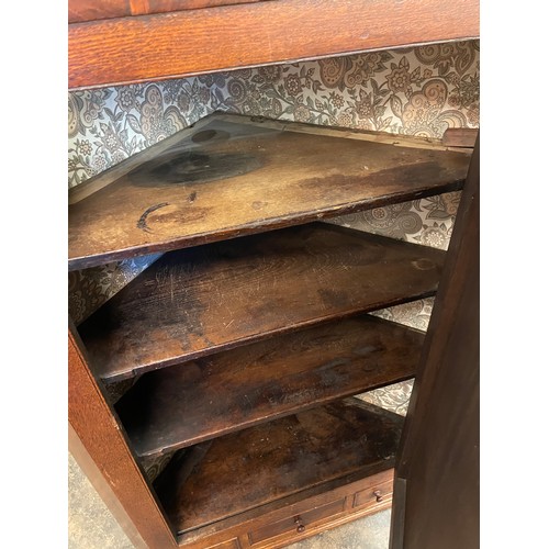 76 - EARLY 19TH CENTURY OAK AND MAHOGANY CROSS BANDED HANGING CORNER CUPBOARD WITH DRAWER BASE