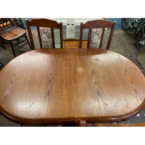 196 - OAK OVAL TRESTLE END DINING TABLE AND FOUR UPHOLSTERED CHAIRS