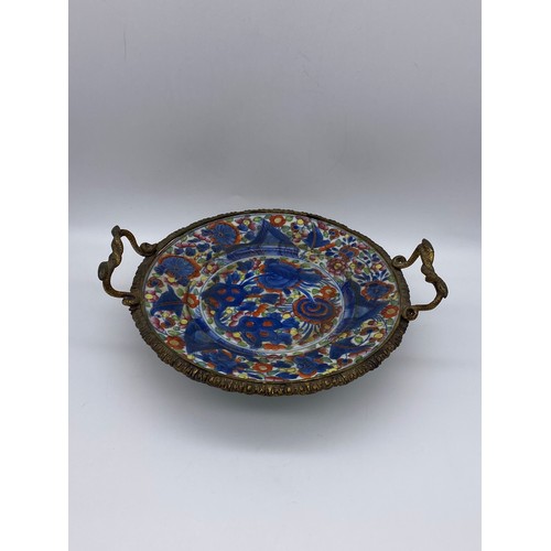 633 - CHINESE POTTERY PLATE CONVERTED TO SERVING TRAY WITH GILT METAL TWIN HANDLED SERPENT DESIGN A/F