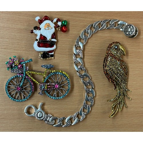 664 - SELECTION OF COSTUME BROOCHES - BICYCLE, PAVE SET PARROT, SANTA CLAUS, AND A QUALITY STAINLESS STEEL... 