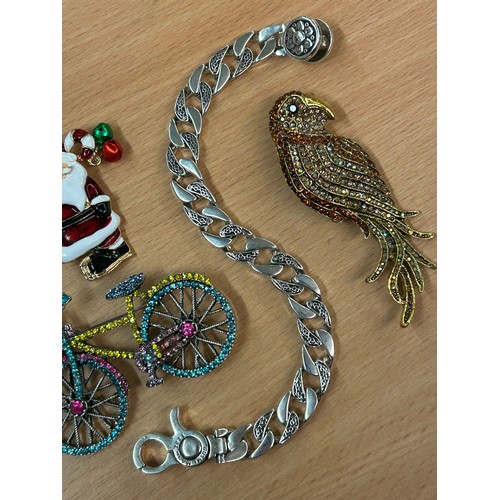 664 - SELECTION OF COSTUME BROOCHES - BICYCLE, PAVE SET PARROT, SANTA CLAUS, AND A QUALITY STAINLESS STEEL... 