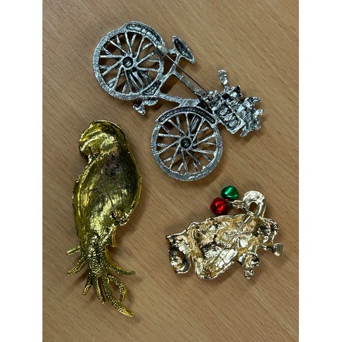 664 - SELECTION OF COSTUME BROOCHES - BICYCLE, PAVE SET PARROT, SANTA CLAUS, AND A QUALITY STAINLESS STEEL... 