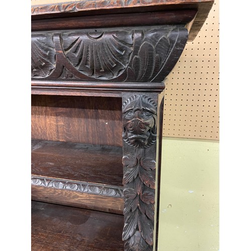 157 - VICTORIAN CARVED OAK OPEN BOOKCASE WITH LIONS HEAD CAPITALS