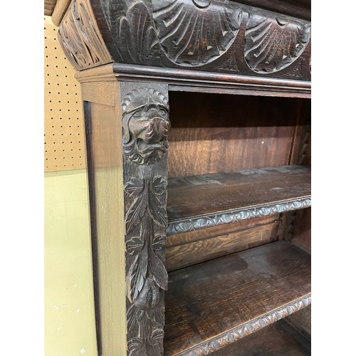 157 - VICTORIAN CARVED OAK OPEN BOOKCASE WITH LIONS HEAD CAPITALS