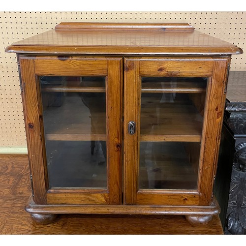 63 - HONEY PINE GLAZED TWO DOOR CABINET ON BUN FEET