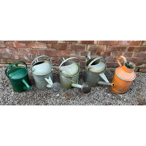 428 - FOUR GALVANISED WATERING CANS AND PAINTED MINIATURE CHURN