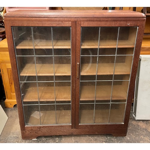 62 - OAK LEADED TWO DOOR BOOKCASE