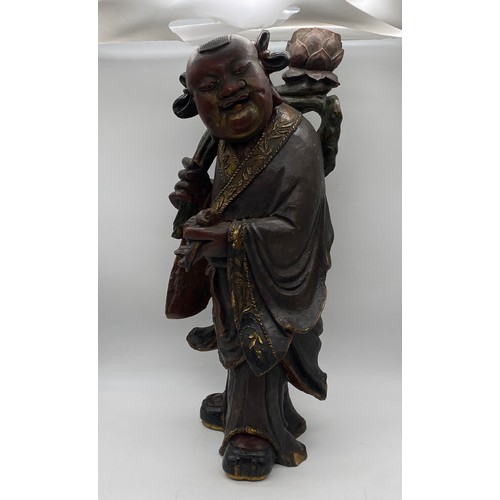 580 - POLYCHROME PAINTED CARVED CHINESE FIGURE HOLDING A BIRD