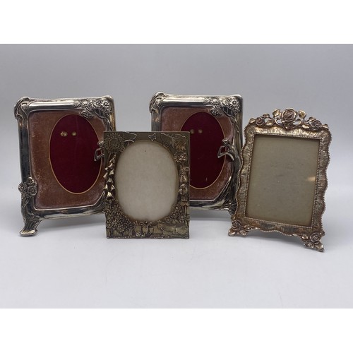 555 - PAIR OF PLATED ART NOUVEAU FIGURAL FLORAL FRAMED EASEL BACKED PHOTO FRAMES AND TWO OTHERS