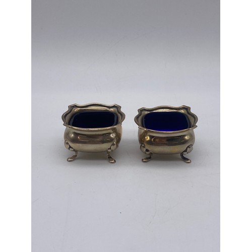 546 - PAIR OF BIRMINGHAM SILVER BOMBE TABLE SALTS WITH BLUE GLASS LINERS