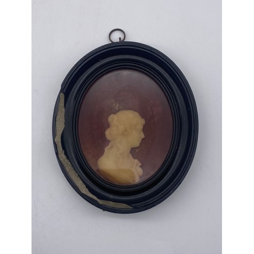 537 - 19TH CENTURY WAXED SILHOUETTE OF A FEMALE PROFILE ON VELVET BACKGROUND IN OVAL FRAME (FRAME A/F)