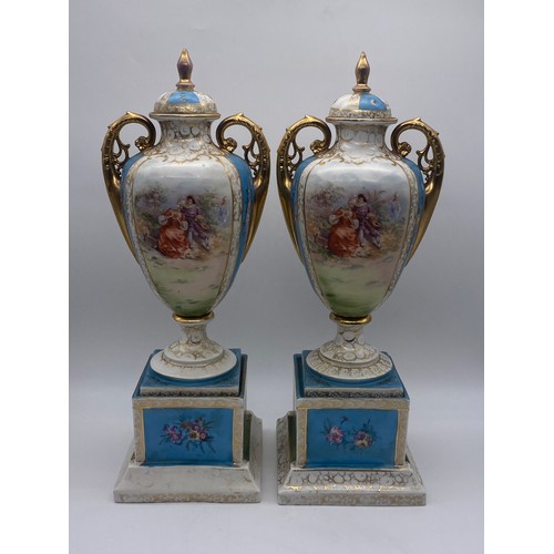 566 - PAIR OF AUSTRIAN VIENNA OVOID PAINTED VASES AND COVERS WITH GILT HANDLES