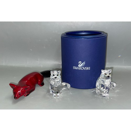 539 - ROYAL DOULTON FLAMBÉ RECUMBENT FOX AND TWO SWAROVSKI SEATED CATS ONE IS A/F