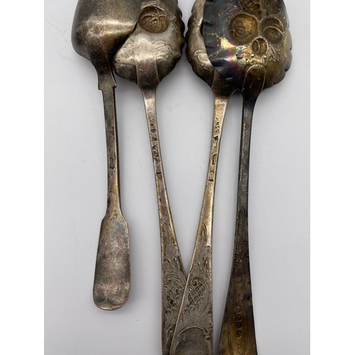 556 - GEORGIAN SILVER BERRY SPOONS AND AN IRISH SILVER SPOON AND NAPKIN RING