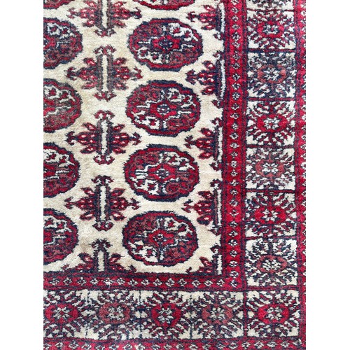 79 - 20TH CENTURY GEOMETRIC PATTERN RED GROUND CARPET