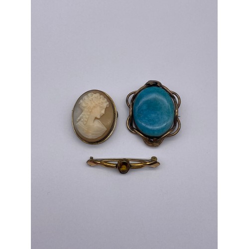457 - BASE METAL MOUNTED CARVED OVAL CAMEO BROOCH, TURQUOISE CERAMIC BROOCH AND A SMALL CITRINE BAR BROOCH