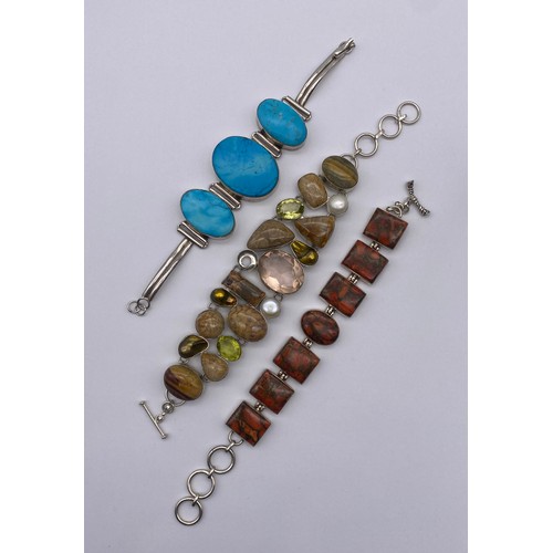 454 - THREE SILVER AND WHITE METAL POLISHED STONE ENCRUSTED CHAIN BRACELETS