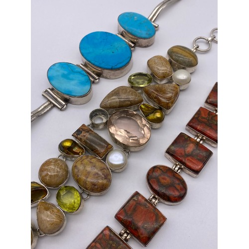 454 - THREE SILVER AND WHITE METAL POLISHED STONE ENCRUSTED CHAIN BRACELETS
