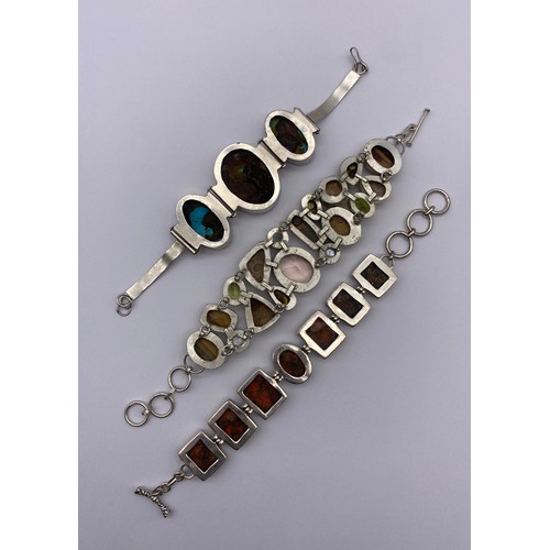 454 - THREE SILVER AND WHITE METAL POLISHED STONE ENCRUSTED CHAIN BRACELETS