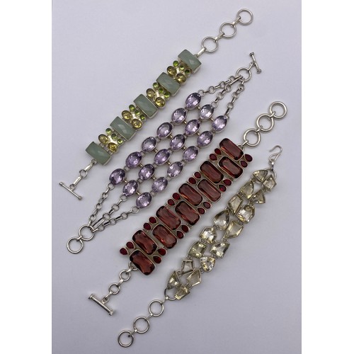 453 - FOUR SILVER AND WHITE METAL STONE ENCRUSTED CHAIN BRACELETS